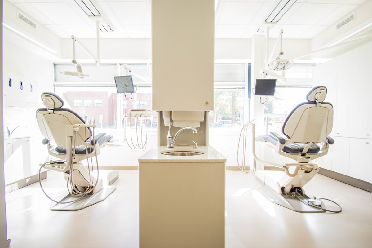 Bright dental clinic with treatment chairs ready for a cleaning appointment
