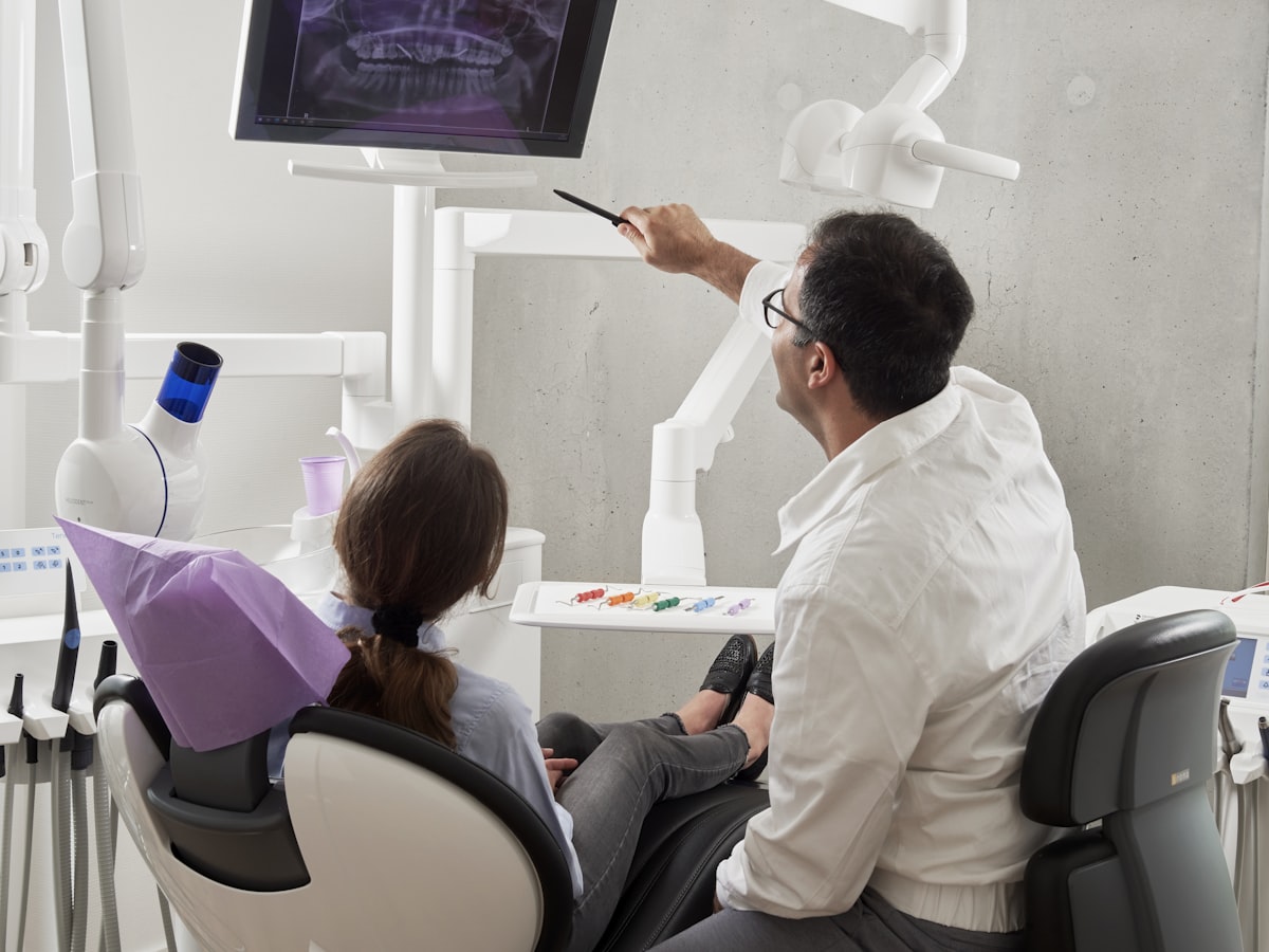 Dentist and patient at Orchid Dental Wellness, Bhopal, reviewing an x-ray while discussing gum recession