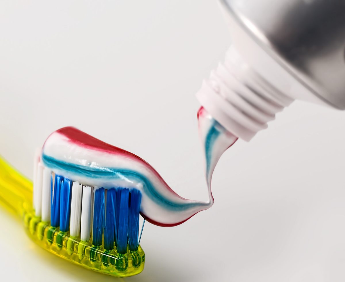Fluoride toothpaste squeezed onto a toothbrush, a simple daily step that helps protect enamel against tooth erosion, from Orchid Dental Wellness, Bhopal
